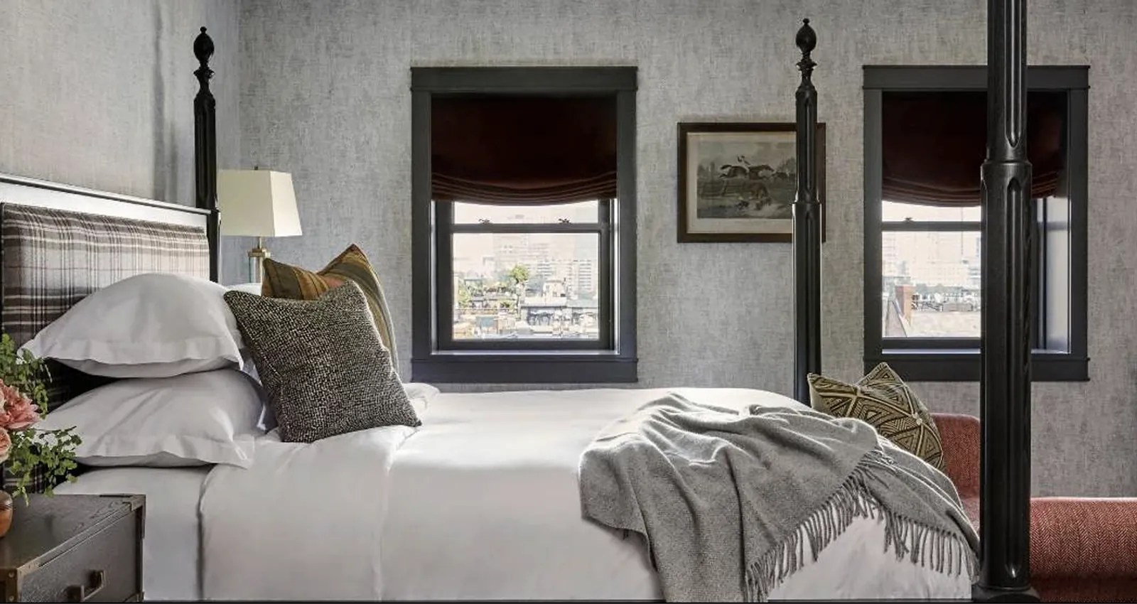 A Baker House apartment bedroom with a four-poster bed and city view