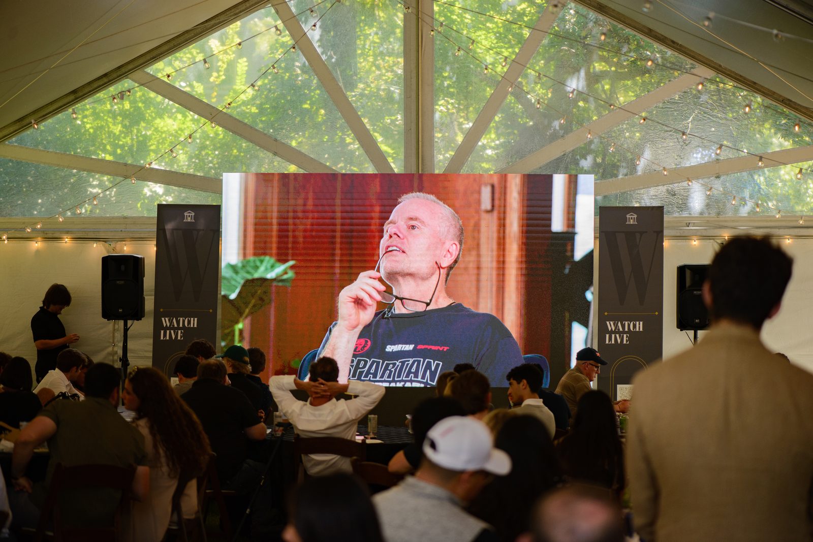 The crowd under the Baker House Challenge tent watching the live screen