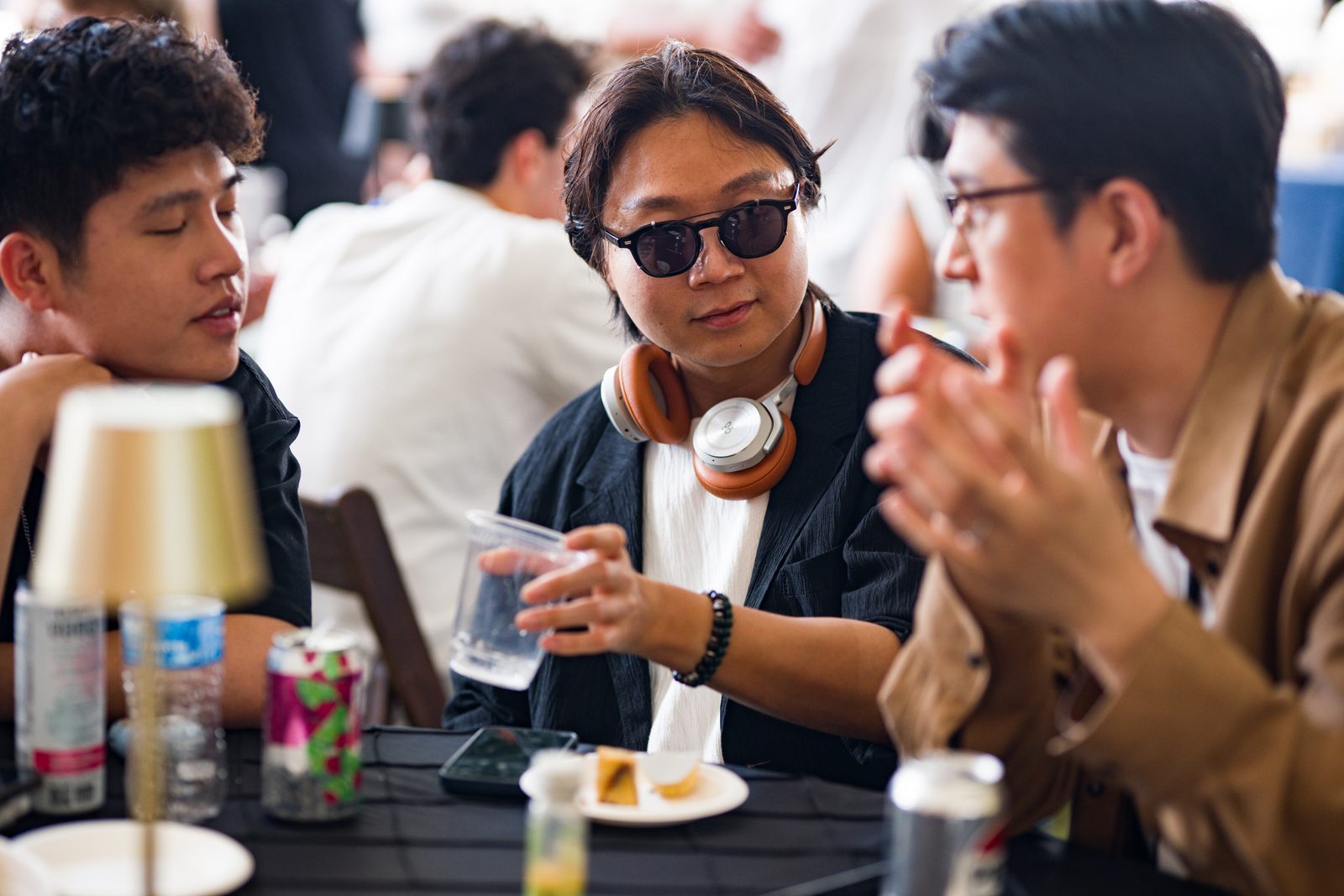 Three guests in conversation at a table during the Baker House Challenge